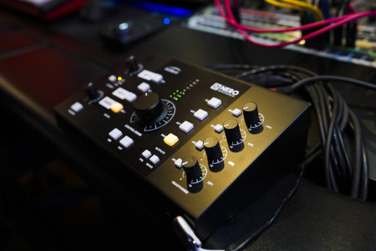 A close up of a black control panel on a desk.